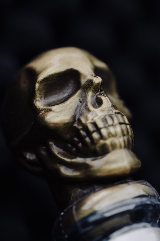 A close-up shot of the metal skull bottle cap of the Padre Azul bottle design