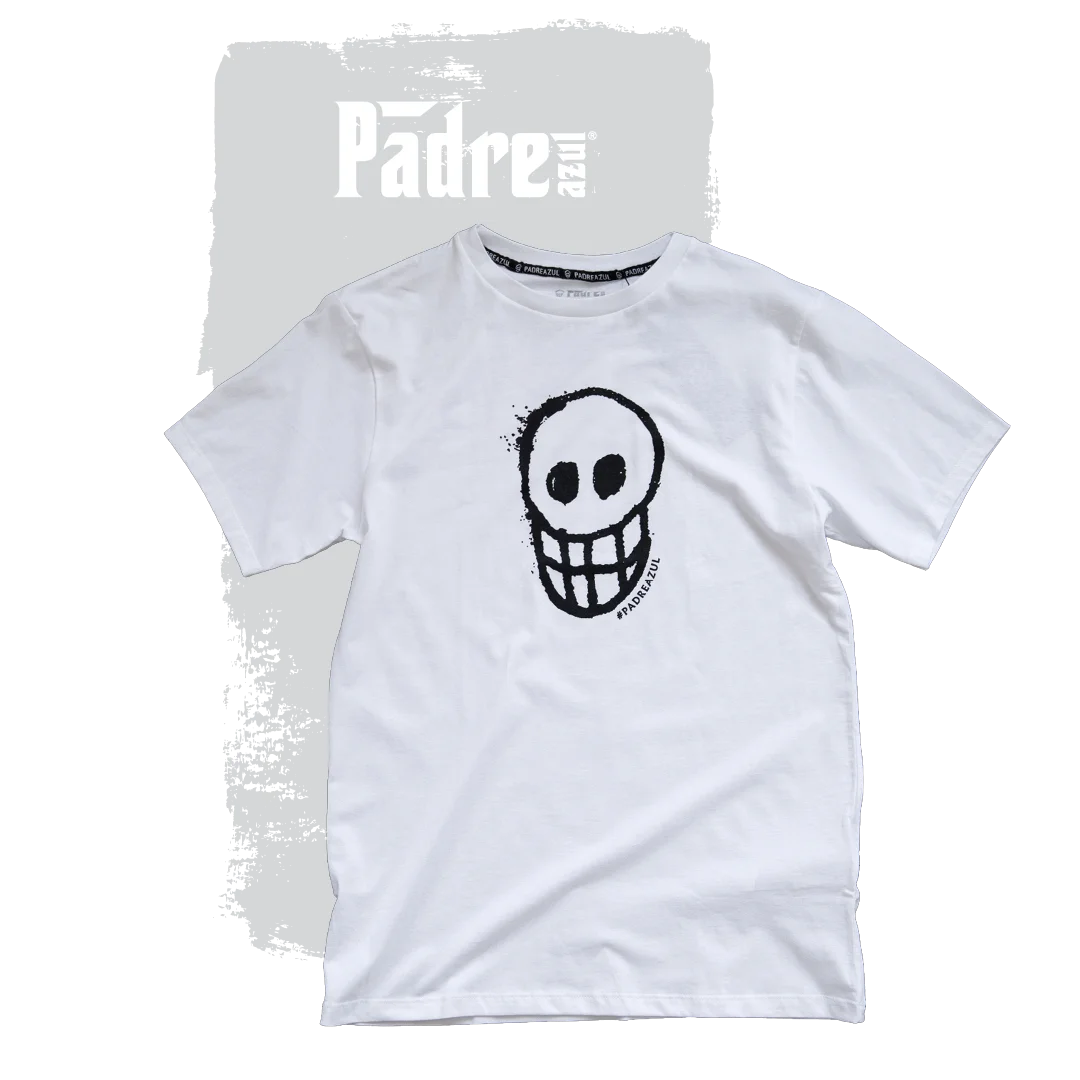 The Padre Azul T-shirt white on a grey background. In the middle of the shirt is a black skull.